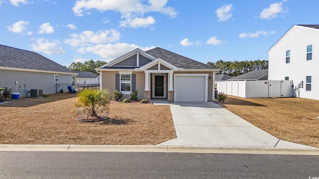 view of front of property with cooling unit and a garage