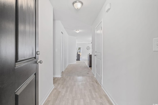 corridor with light hardwood / wood-style flooring