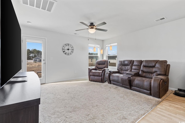 living room featuring ceiling fan and light hardwood / wood-style floors