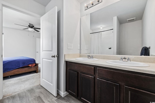 bathroom with hardwood / wood-style flooring, vanity, and ceiling fan