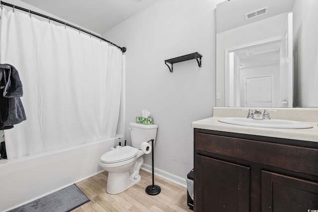 full bathroom with hardwood / wood-style flooring, vanity, shower / bathtub combination with curtain, and toilet