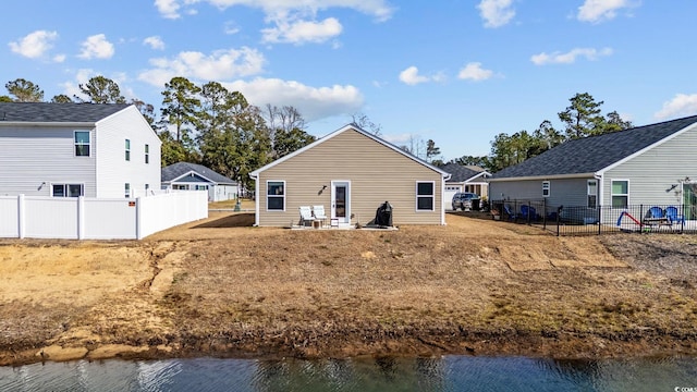 rear view of house with a water view