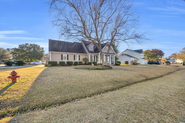 cape cod home featuring a front yard