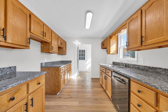 kitchen featuring a sink, baseboards, light wood-type flooring, dishwasher, and brown cabinetry