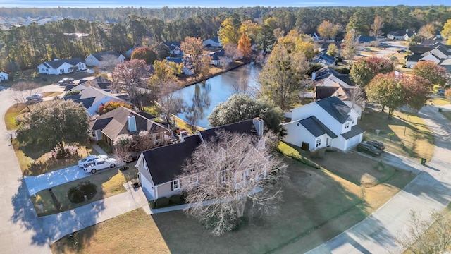 bird's eye view with a forest view, a water view, and a residential view