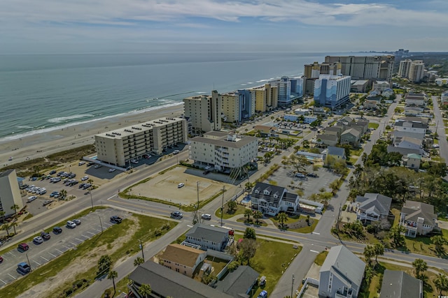 drone / aerial view featuring a beach view and a water view