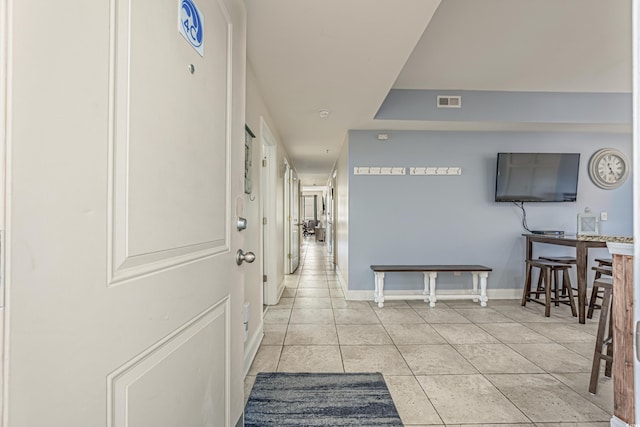 hall featuring light tile patterned floors