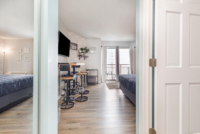 bedroom featuring access to outside and light hardwood / wood-style floors