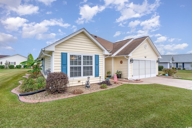 view of front of house with a garage and a front lawn