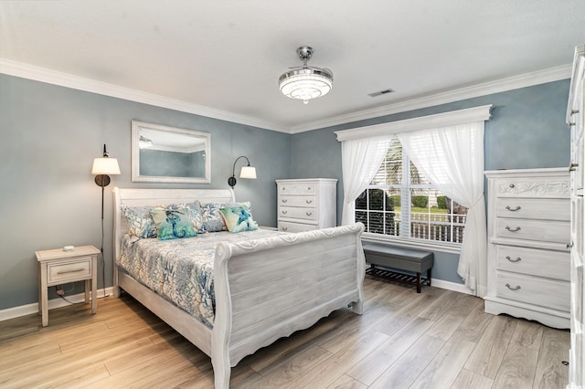 bedroom with ornamental molding and light wood-type flooring