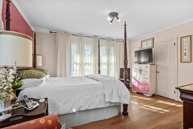 bedroom featuring crown molding and hardwood / wood-style flooring