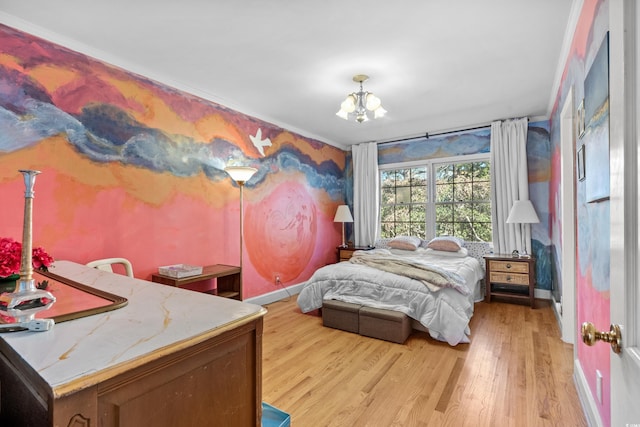 bedroom with an inviting chandelier and light hardwood / wood-style flooring