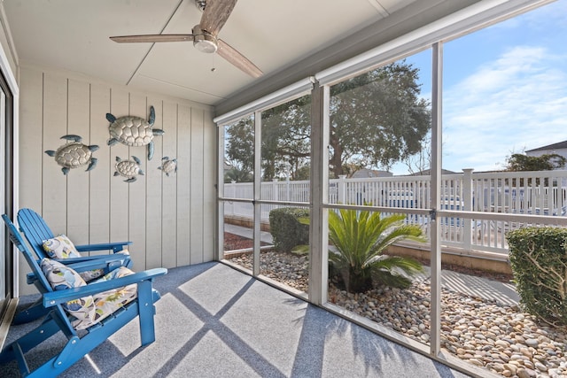 sunroom / solarium featuring ceiling fan