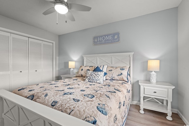 bedroom with hardwood / wood-style flooring, ceiling fan, and a closet