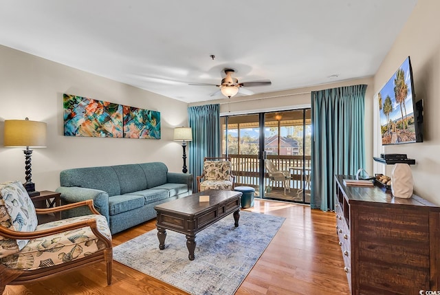 living room featuring ceiling fan and light hardwood / wood-style flooring