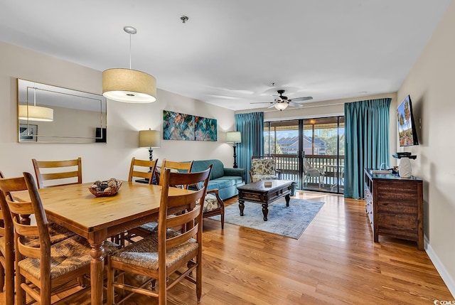 dining area featuring ceiling fan and light wood-type flooring