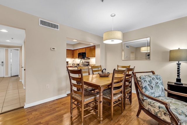 dining area with light hardwood / wood-style floors