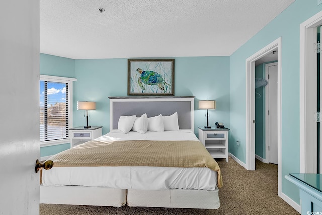 bedroom with a textured ceiling and carpet flooring