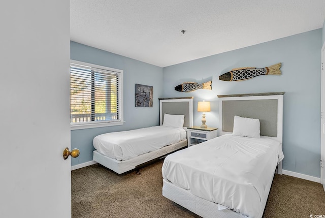 carpeted bedroom featuring a textured ceiling