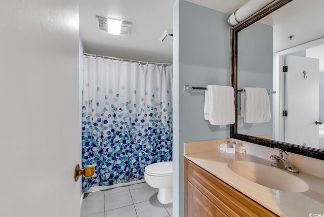 bathroom with vanity, tile patterned floors, toilet, and walk in shower