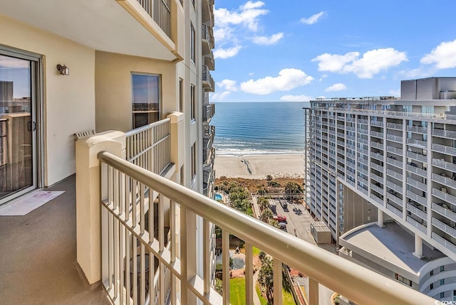 balcony featuring a view of the beach and a water view