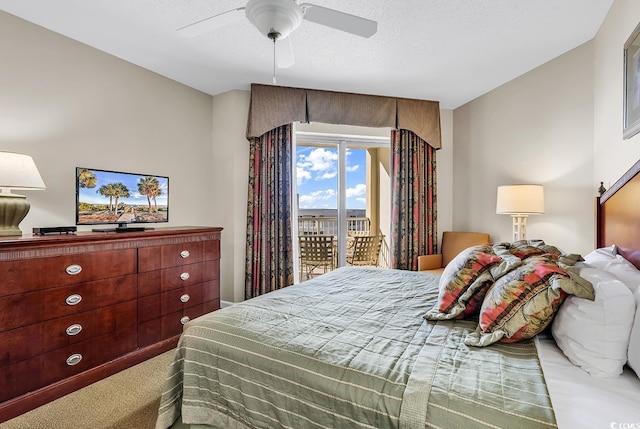 carpeted bedroom with ceiling fan, access to outside, and a textured ceiling