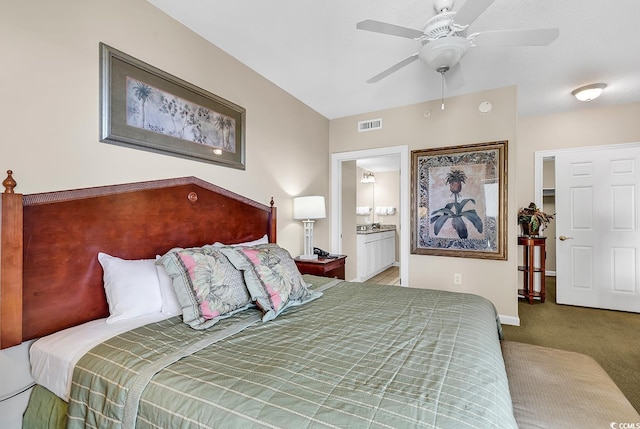 bedroom featuring ceiling fan, ensuite bath, and carpet floors