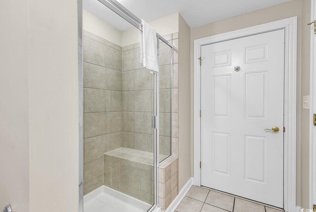 bathroom featuring an enclosed shower and tile patterned floors