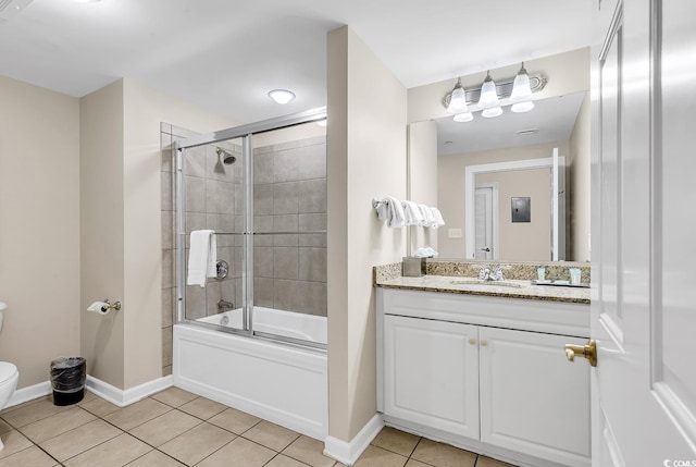 full bathroom featuring tile patterned flooring, vanity, toilet, and combined bath / shower with glass door