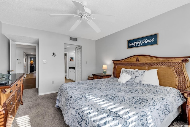 carpeted bedroom with ceiling fan, a closet, and a textured ceiling