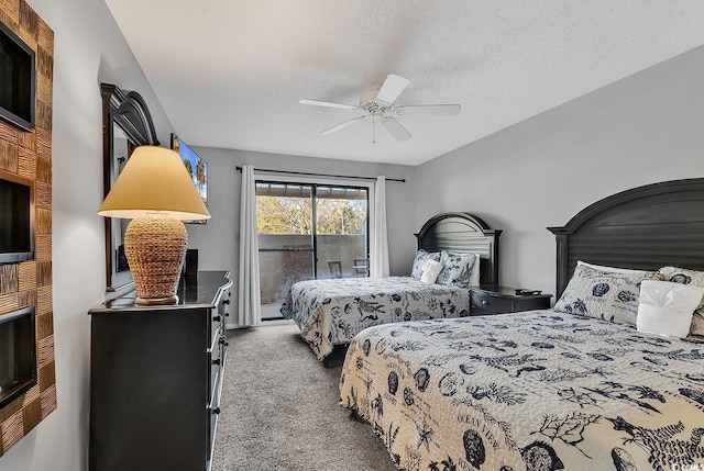 carpeted bedroom with ceiling fan, access to exterior, and a textured ceiling