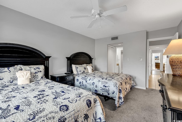 carpeted bedroom with a textured ceiling and ceiling fan