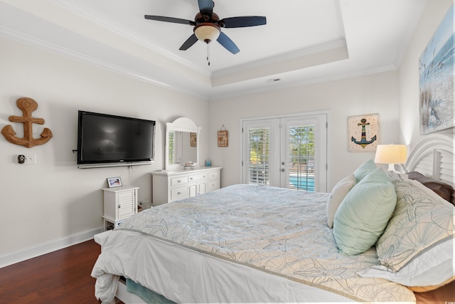 bedroom featuring french doors, crown molding, dark hardwood / wood-style floors, a tray ceiling, and access to exterior