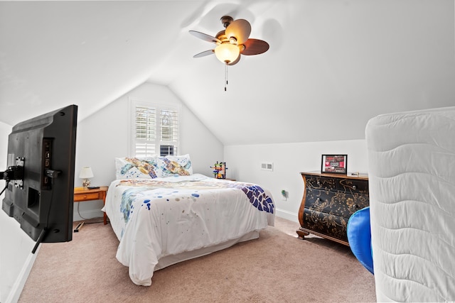 carpeted bedroom with ceiling fan and vaulted ceiling