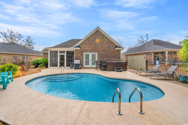 view of pool featuring area for grilling, a hot tub, a patio area, and a sunroom