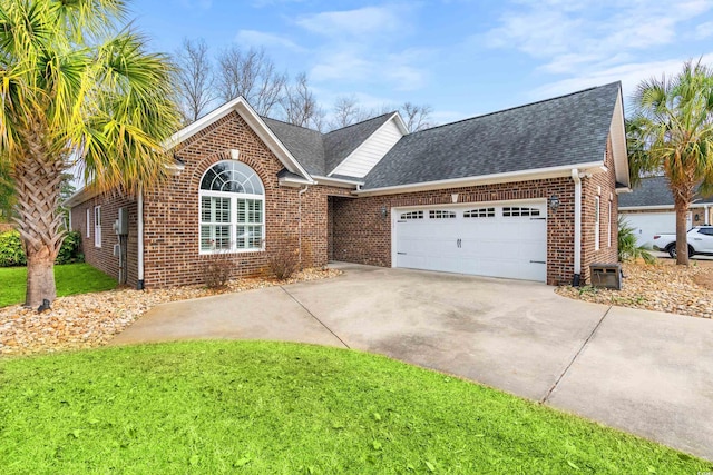 view of front of house with a garage and a front lawn