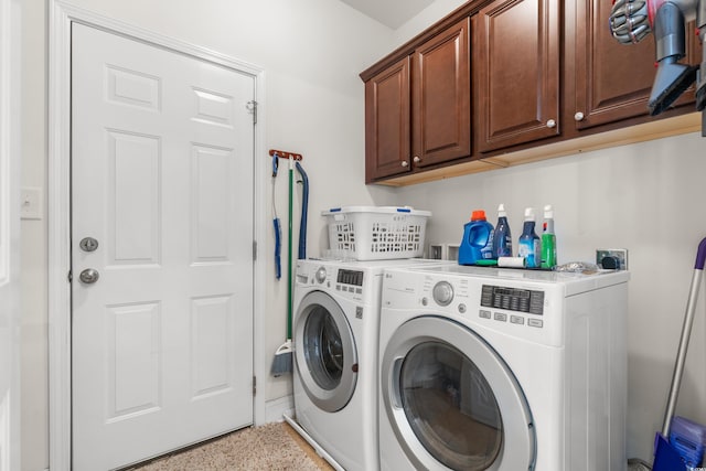 laundry area featuring washing machine and dryer and cabinets