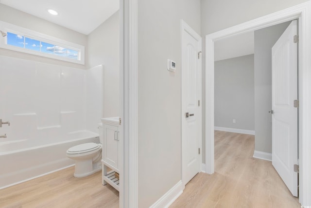 full bathroom featuring vanity, hardwood / wood-style floors, shower / tub combination, and toilet