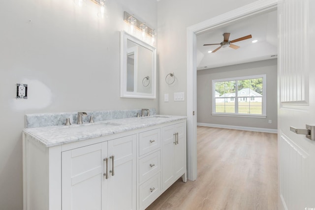 bathroom with hardwood / wood-style flooring, vanity, and ceiling fan