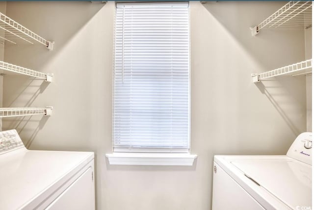 laundry area with laundry area and washing machine and clothes dryer