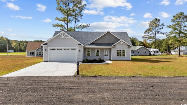 view of front of property with a garage and a front lawn