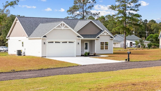 view of front of house with cooling unit and a front lawn