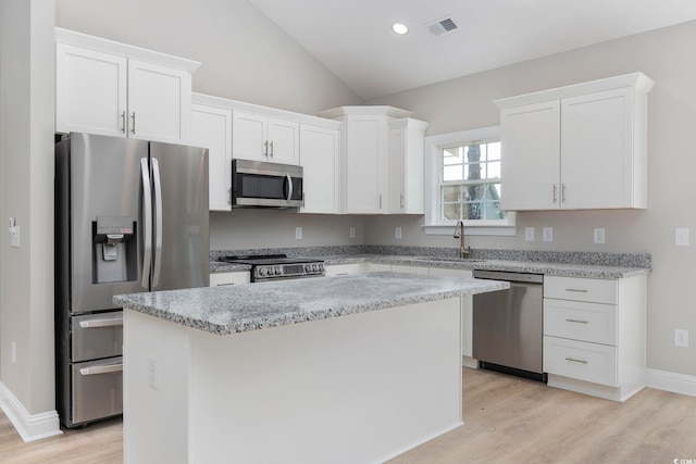 kitchen featuring a center island, white cabinets, and appliances with stainless steel finishes