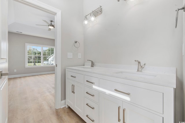 bathroom featuring hardwood / wood-style flooring, ceiling fan, and vanity