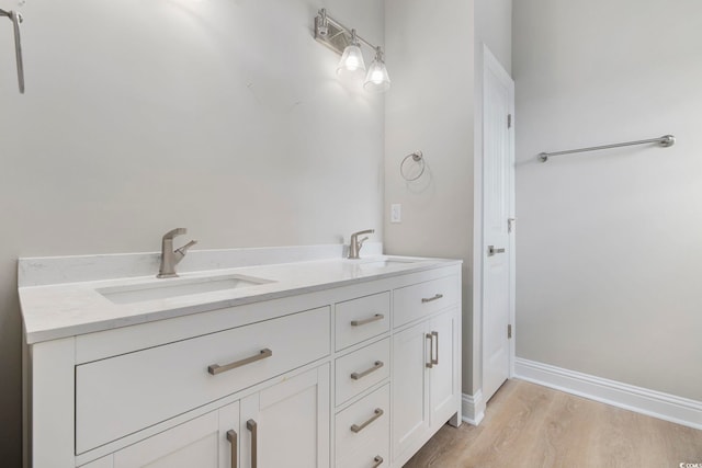 bathroom with hardwood / wood-style flooring and vanity