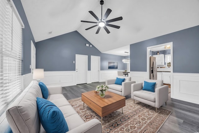 living room featuring ceiling fan, lofted ceiling, dark hardwood / wood-style flooring, and plenty of natural light