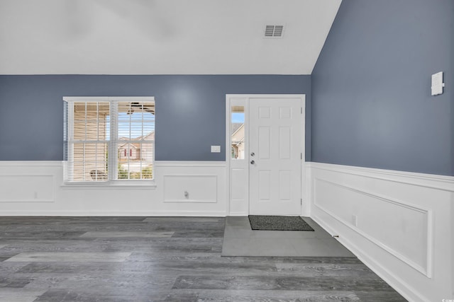 entrance foyer featuring dark wood-type flooring and vaulted ceiling