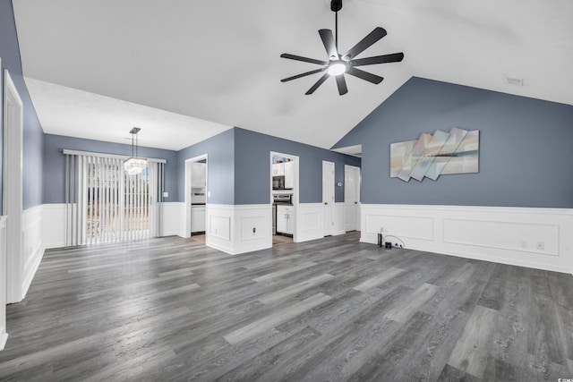 unfurnished living room with ceiling fan with notable chandelier, vaulted ceiling, and dark hardwood / wood-style floors