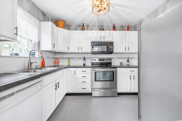 kitchen featuring white cabinetry, appliances with stainless steel finishes, sink, and light tile patterned flooring