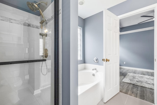 bathroom with hardwood / wood-style floors, separate shower and tub, and ceiling fan